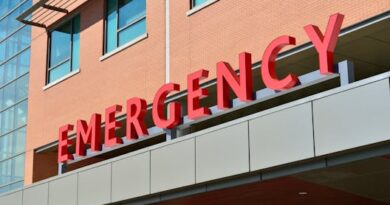 Close-up of a modern hospital emergency room entrance with prominent red letters.